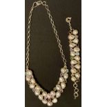 A sterling silver necklace and bracelet part suite, set with an arrangement of cultured pearls and