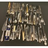 A collection of silver mounted flatware, button hooks, sewing implements, manicure utensils, etc