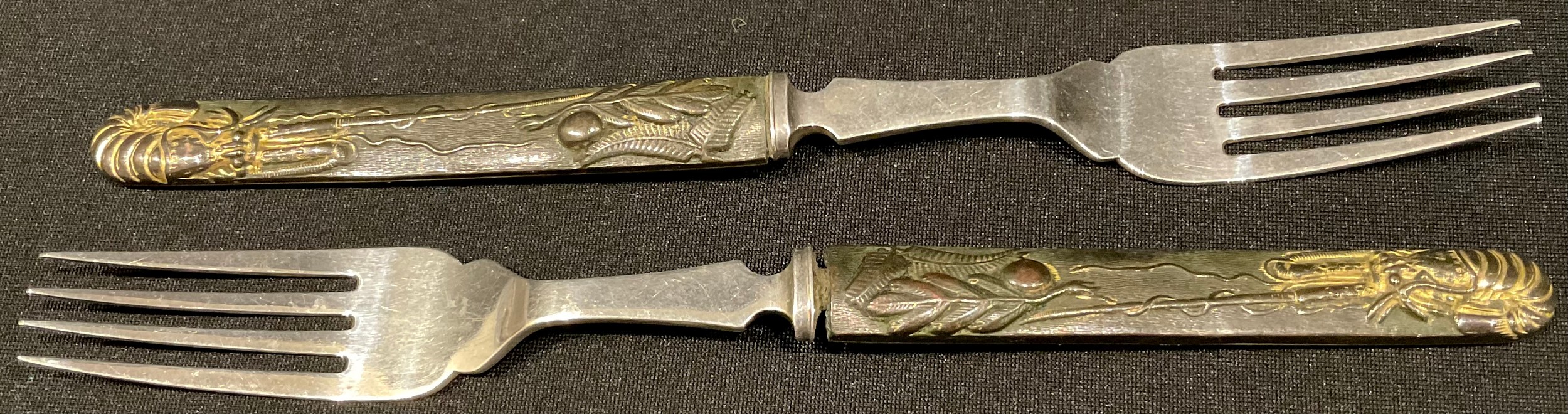 Japanese Arms and Armour - a pair of silver table forks, the parcel-gilt bronze handles formed