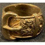 A 9ct gold buckle ring, chased and engraved with a band of scrolls, size V, 18.9g