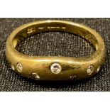 An 18ct gold wishbone shaped ring, set with seven brilliant cut diamond chips, size O, marked 750,