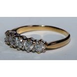 A diamond quintet line ring, linear set with five conforming round brilliant cut diamonds, total