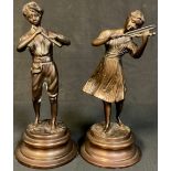 A pair of bronzed metal figures, as peasant musicians, 25.5cm high