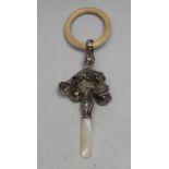 A George V silver, mother-of-pearl and bone baby's rattle, four bells, 13cm long, Crisford &