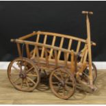 A country house dog cart or garden cart, iron-bound spoked wheels, the carrying bed 67cm high (