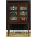 A 19th century Chippendale design mahogany library bookcase on stand, outswept cornice with dentil
