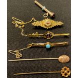 A late 19th century 9ct gold brooch set with ruby and diamond chips; other 9ct gold brooches set