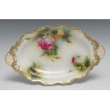 A Royal Worcester shaped oval dish, painted with pink and yellow roses on a mottled ground,