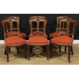 A set of six late Victorian Aesthetic Movement oak and ebonised dining chairs, stuffed-over seat,