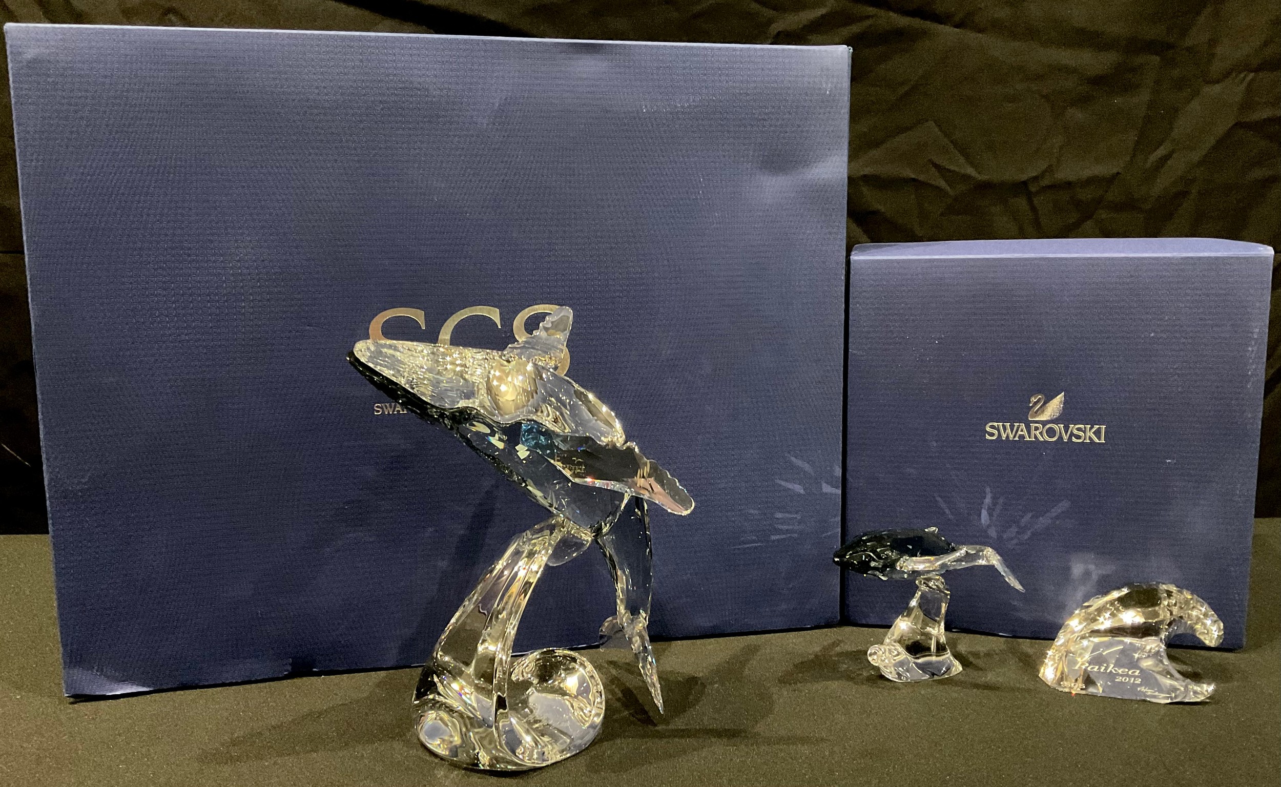 A Swarovski Crystal model, Paikea Whale, boxed, certificate; another, Whale Calf, boxed (2)