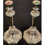 A pair of silver plated candlesticks, campana shaped sconces, tapering column, shaped bases, 31cm