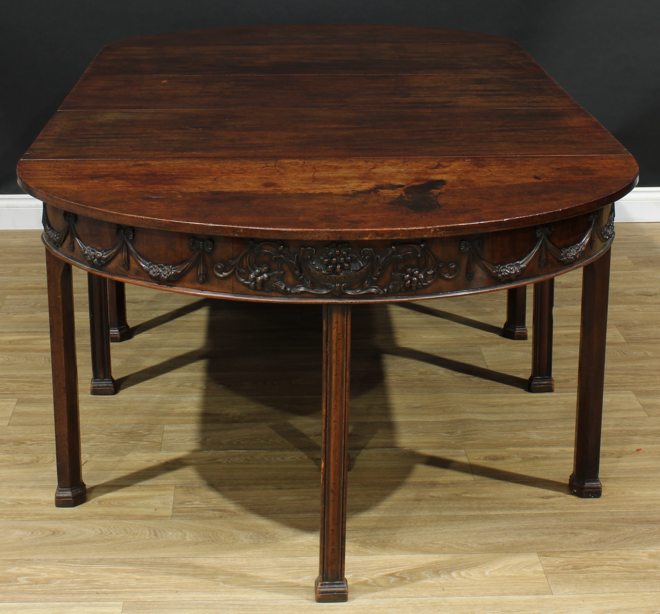 A 19th century Adam Revival mahogany D-end dining table, comprising a pair of demilune end