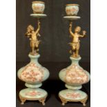 A pair of reproduction Empire style bronzed metal and porcelain candle sticks, 36cm high