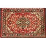A Middle Eastern rectangular woollen carpet, 189cm x 125cm