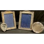 A pair of hallmarked silver photograph frames; others, circular and heart shaped (4)