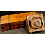 An early 20th century mahogany folding plate camera, concertina movement, The Cambridge Camera, M&