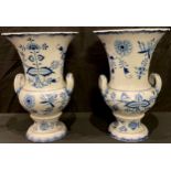 A pair of Meissen onion pattern two handled urn shaped vases, 24cm high