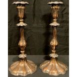 A pair of Sheffield plate on copper candlesticks, engraved with scrolls and flowers, 30cm high