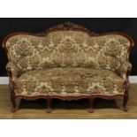 A Victorian walnut sofa, shaped cresting rail carved with flowerheads and leaves, stuffed-over