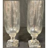 A pair of reproduction Victorian style cut glass storm lamps, stepped base, 34cm high