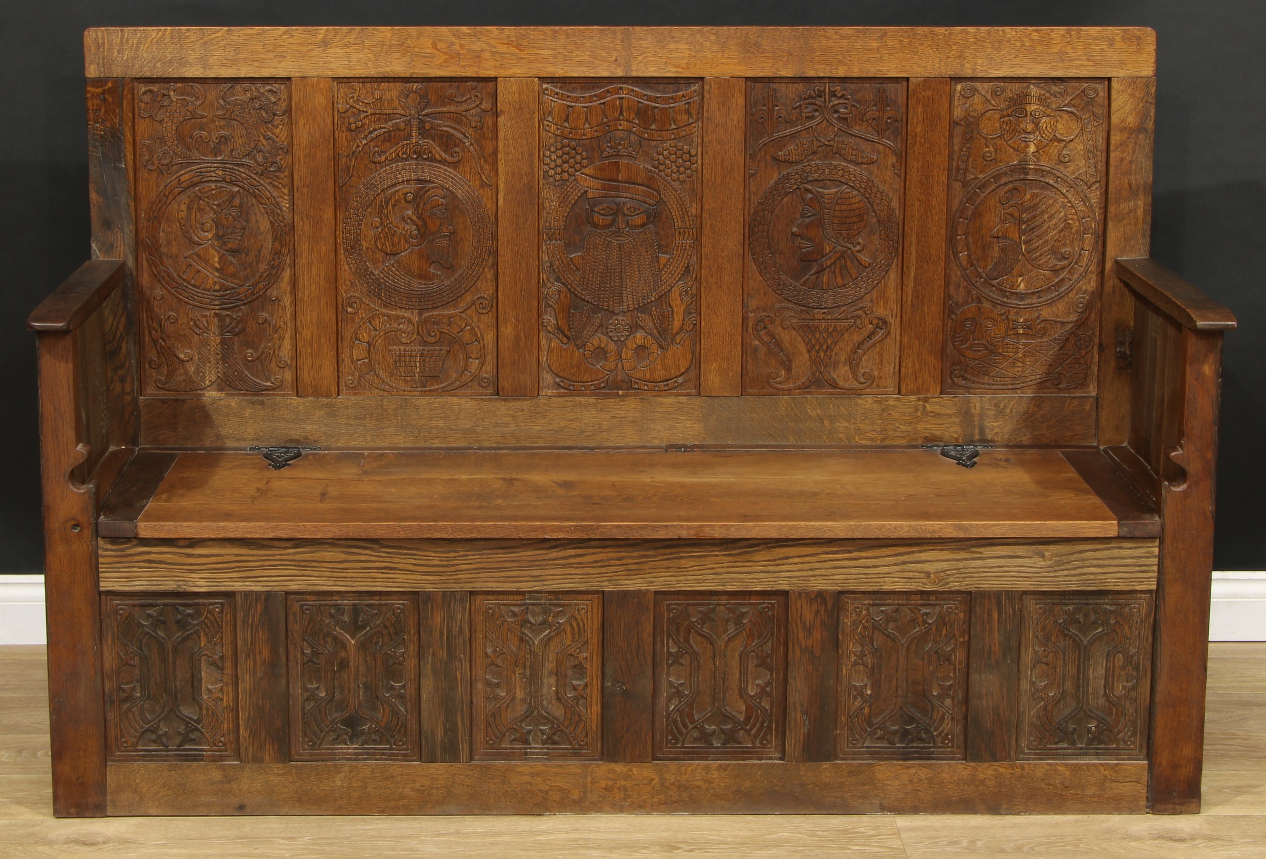 A contemporary Historicist Revival oak box settle, set with a carved animal signature, rectangular