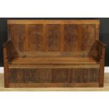 A contemporary Historicist Revival oak box settle, set with a carved animal signature, rectangular