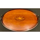 An Edwardian mahogany, twin handled gallery tray of oval form, the central cartouche inlaid with