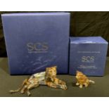 A Swarovski Crystal model, Akili lioness, boxed; a lion cub, boxed (2)