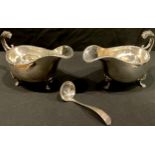 A pair of George V silver sauce boats, gadrooned borders, scroll handles with lion masks, each