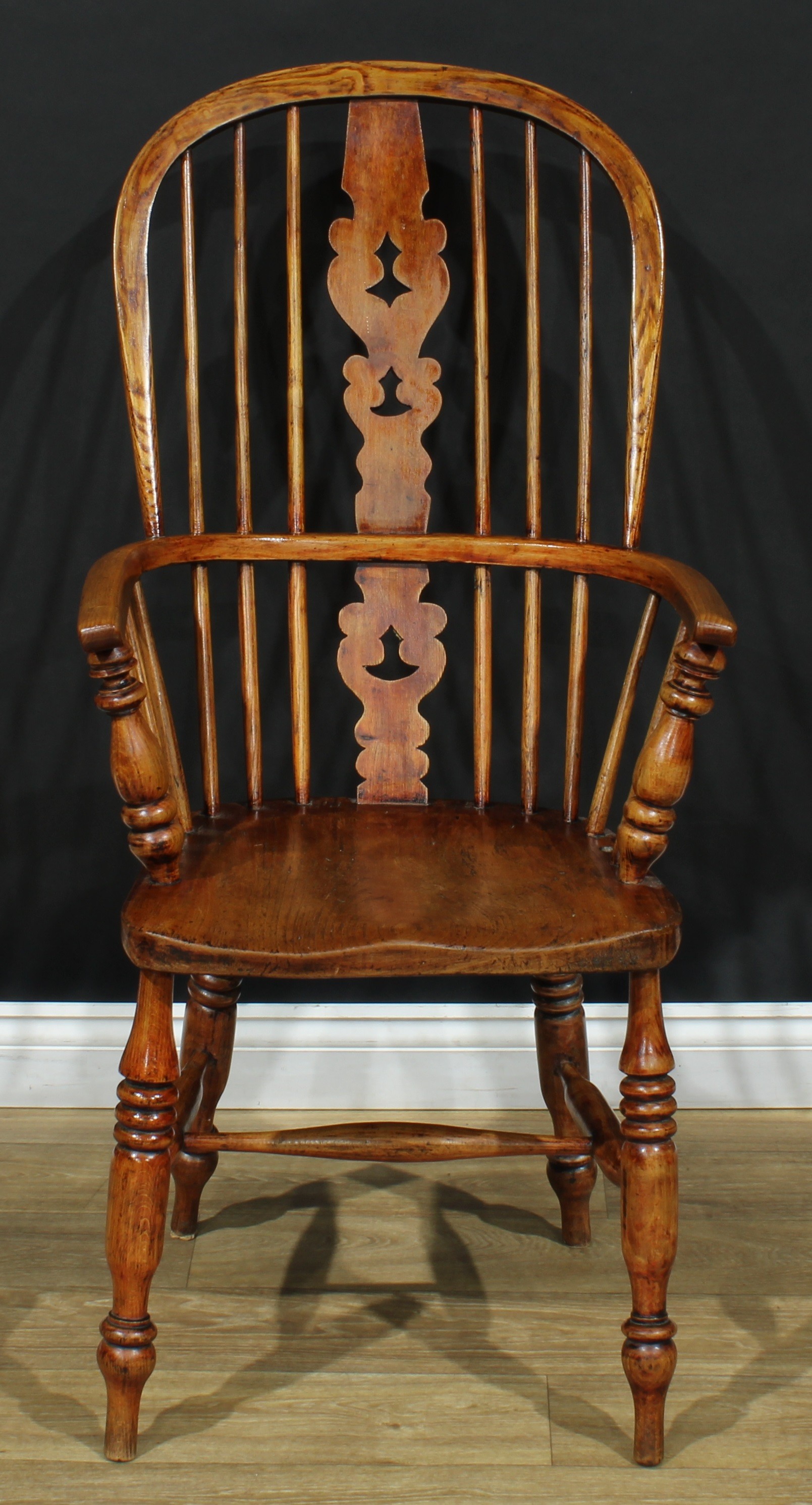 A 19th century Yorkshire Windsor elbow chair, hoop back, shaped and pierced 'Christmas Tree'