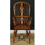 A 19th century Yorkshire Windsor elbow chair, hoop back, shaped and pierced 'Christmas Tree'