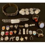 A collection of twenty three silver charms; a silver identity bracelet; silver threepenny bit