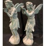 A pair of cast iron garden fairies, one drinking from a leaf, the other with a bird, each 52cm high