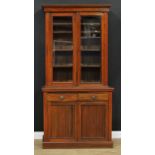 A late Victorian/Edwardian library bookcase, moulded cornice above a pair of glazed doors