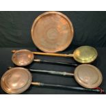 Four 19th century copper and brass warming pans; a Persian copper tray, 55cm diameter (5)