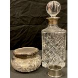 An early 20th century silver topped dressing table jar, London hallmarks; a cut glass decanter