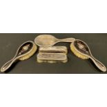 An early 20th century silver and tortoiseshell four piece vanity set, London 1912; another brush,