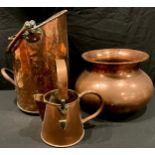 A 19th century copper coal scuttle, swing handle, 45.5cm high; a copper watering can, 30cm high; a