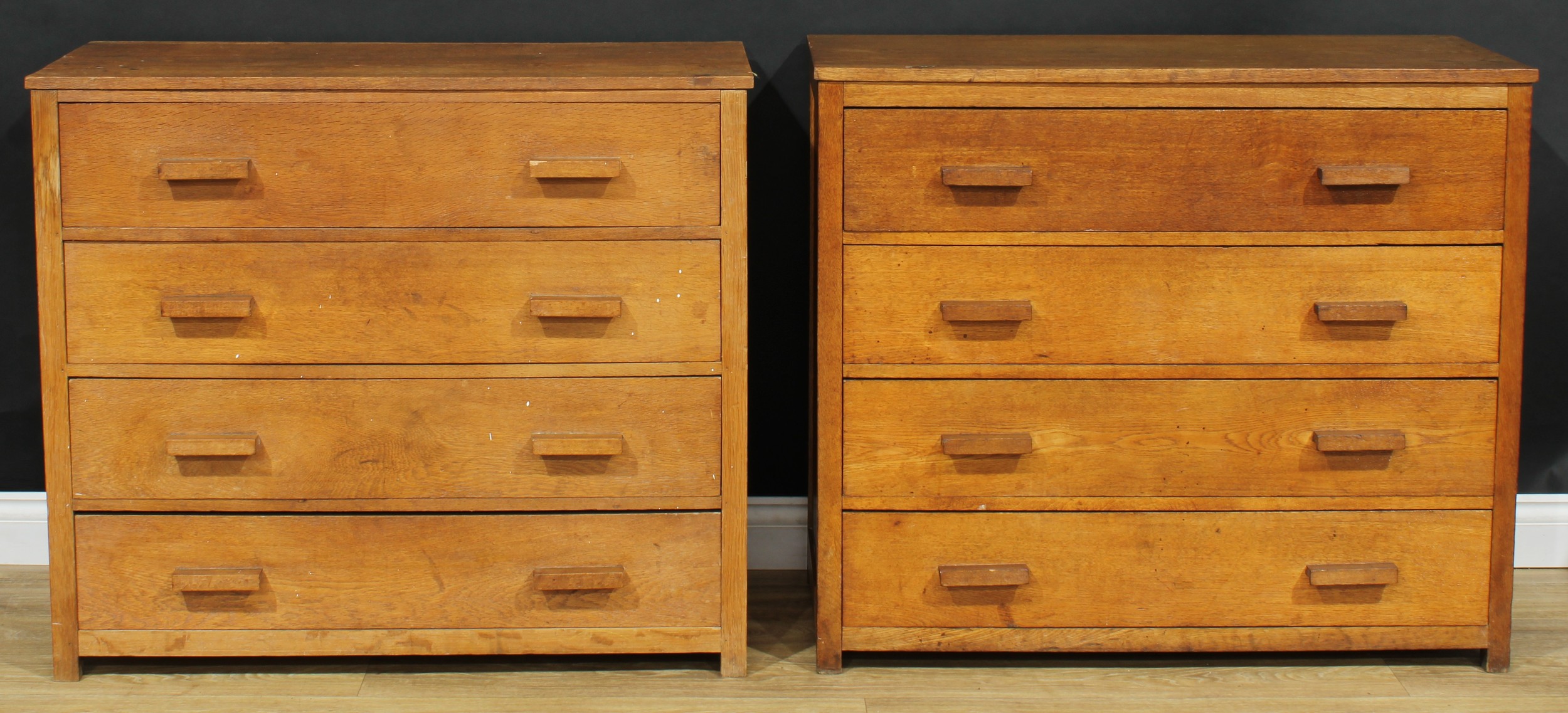 A pair of Arts & Crafts period Cotswold School design chests, each with a rectangular top above four