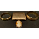 A gold plated cigarette case; a rolled gold bangle; another bangle; a cameo brooch (4)