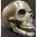 A cast metal model of a human skull, with articulated lower jaw, 9.5cm high