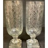A large pair of reproduction Victorian style cut glass storm lamps, stepped base, approx. 40cm high