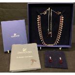 A Swarovski crystal/ruby necklace; matching earrings and pendant on chain; Swarovski jewellery