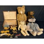 Toys - a mid 20th century straw filled teddy bear with amber and black glass eyes, pronounced snout,
