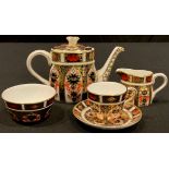 A Royal Crown Derby Imari 1128 pattern miniature teapot, cup and saucer, milk jug and sugar bowl,