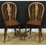 A pair of 19th century Windsor-form side chairs, each with a hoop back, shaped splat, saddle seat,