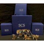 A Swarovski Crystal model, Tiger, signed, dated 2010, boxed; a Swarovski seated Tiger cub, boxed;