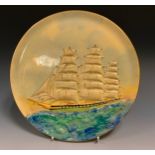 A Grays pottery circular wall plaque, relief decorated with a three masted ship at full sail, 27.5cm