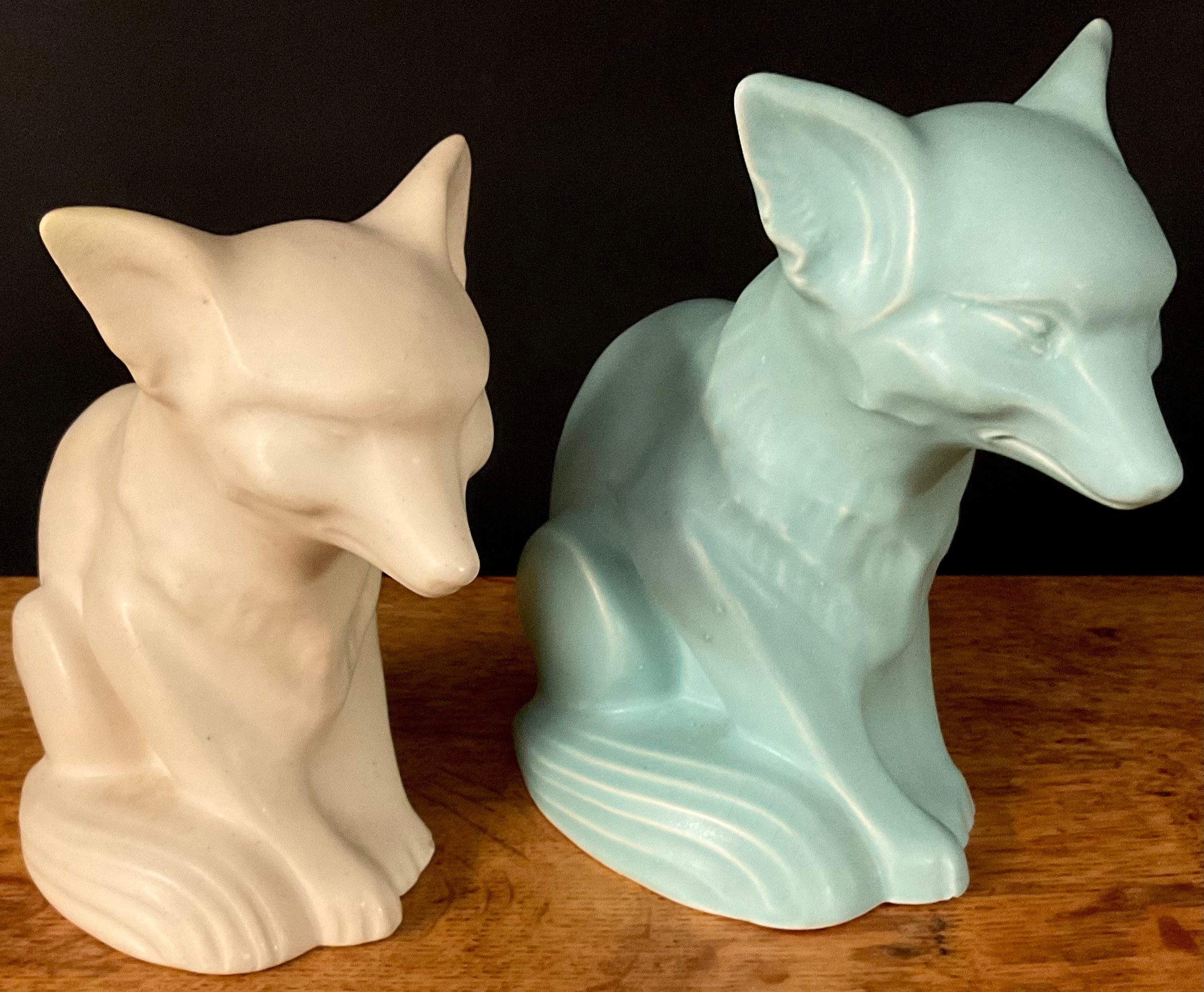 A Langley Mill fox, in green, 18cm high; another, in cream, 16cm high, printed marks (2)