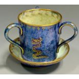 A Wedgwood Dragon lustre three-handled loving cup, designed by Daisy Makeig-Jones, printed in gilt